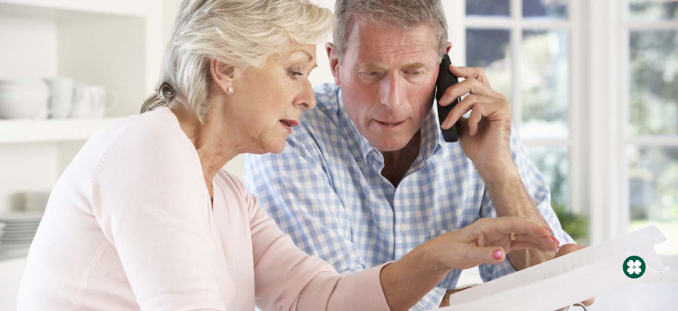 Retirement age couple looking at documents