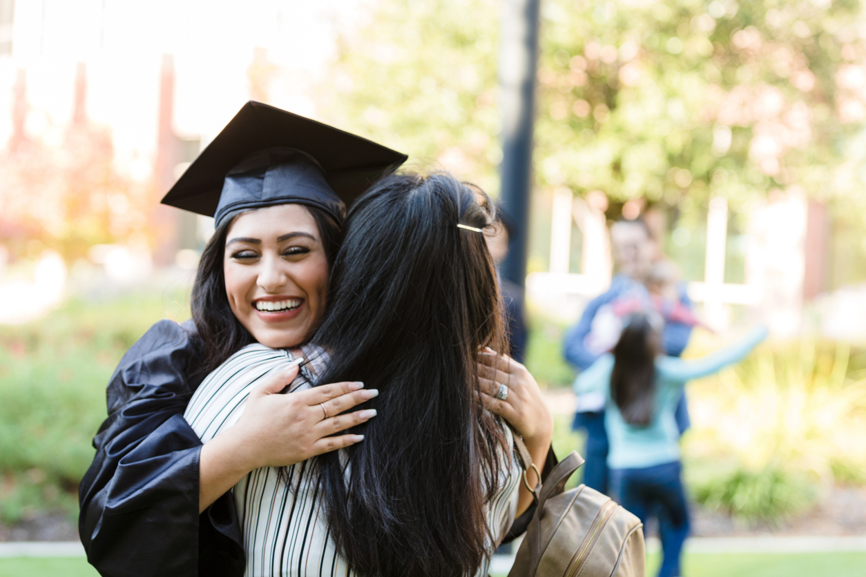 College graduate hugging mom