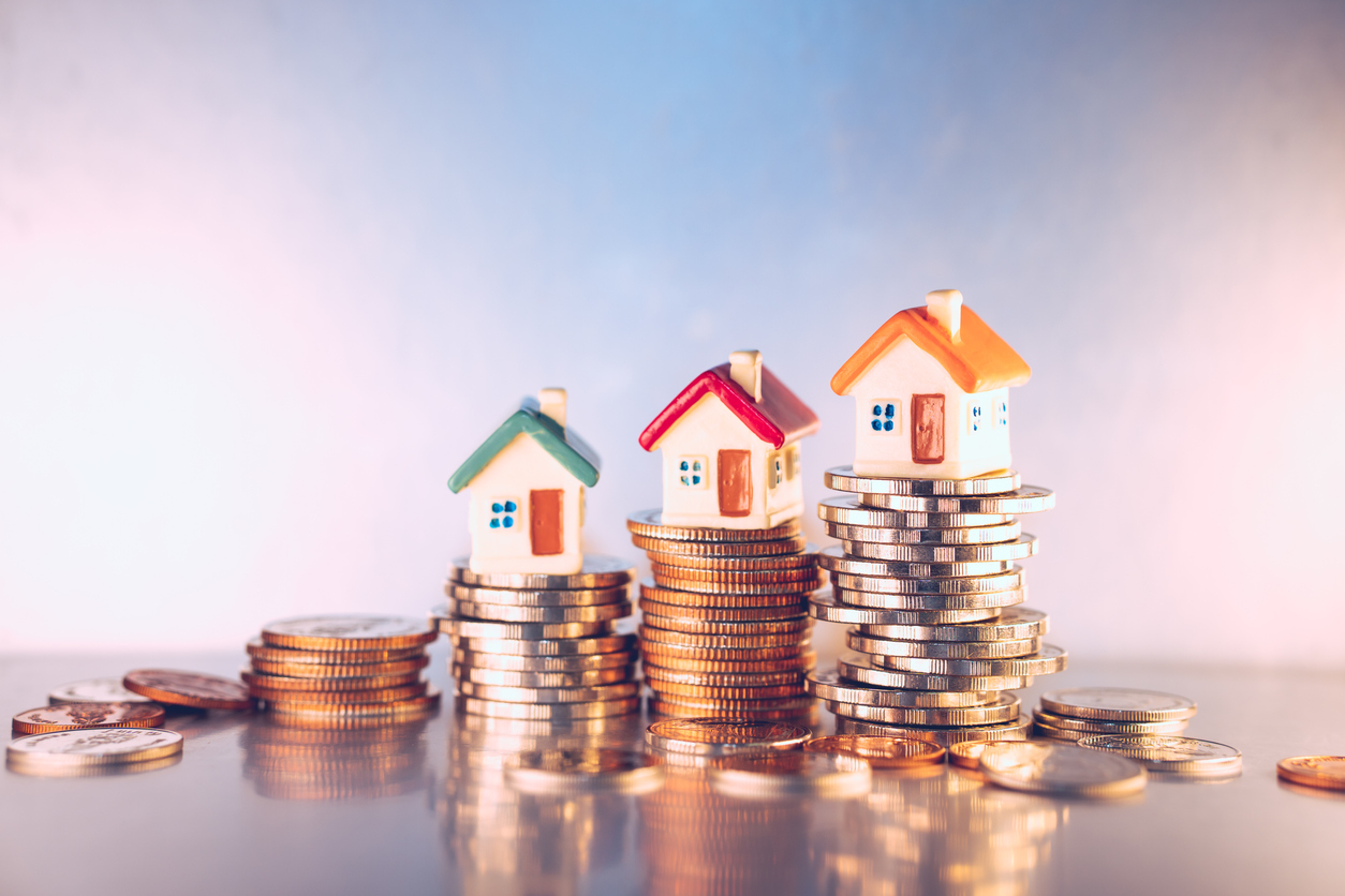 Houses sitting on top of coins