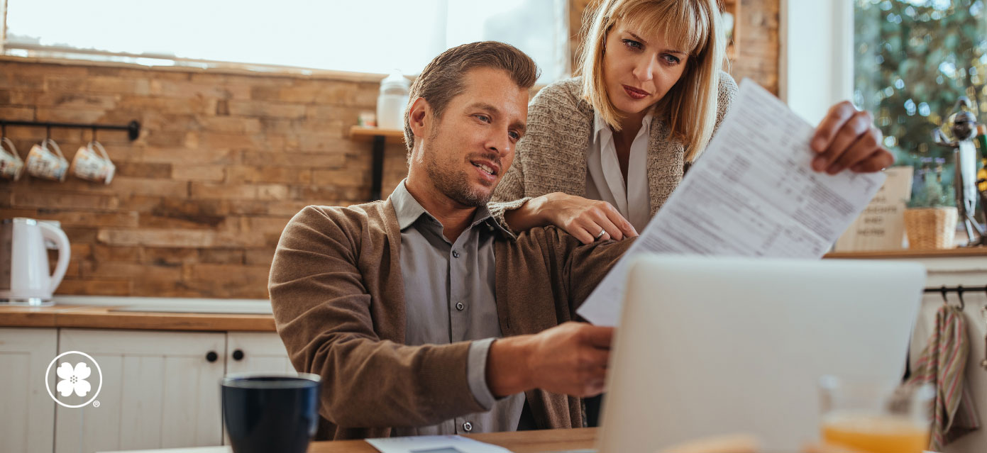 Young couple reviewing paper document