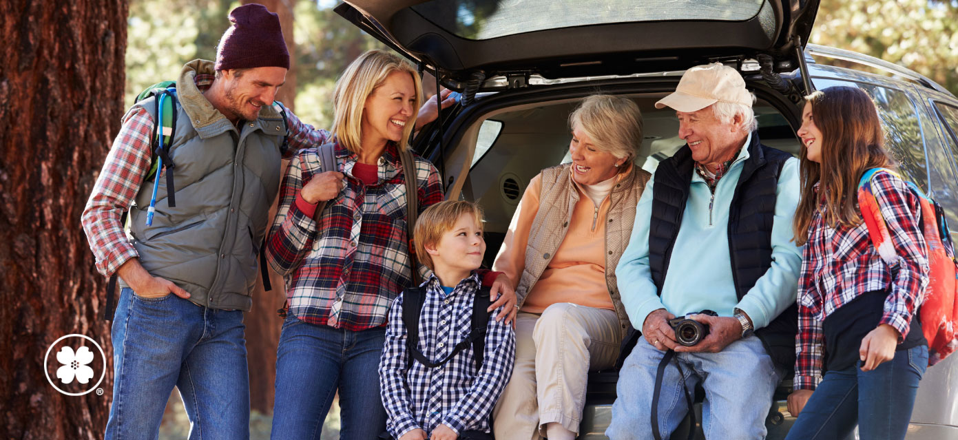 Group of people varying in age standing outside