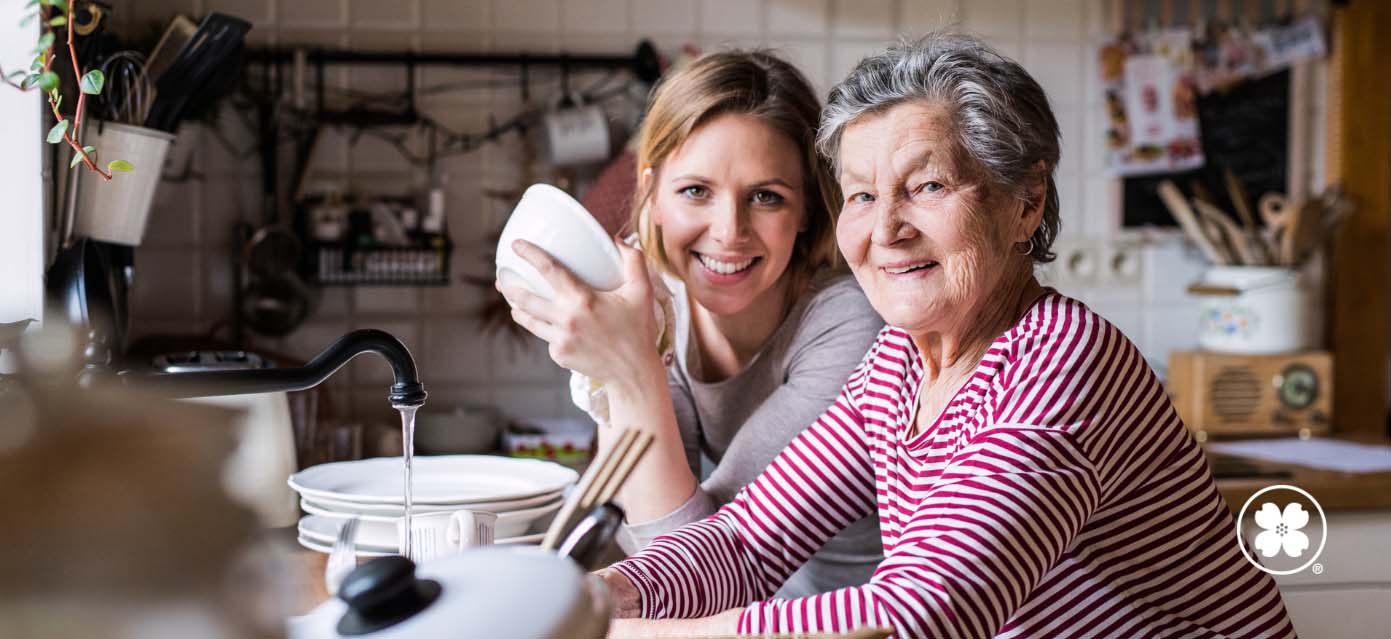 aging mother with daughter cooking together