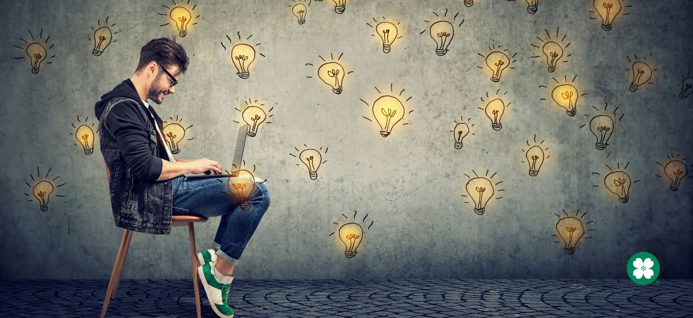 man sitting on chair with cartoon lightbulb background