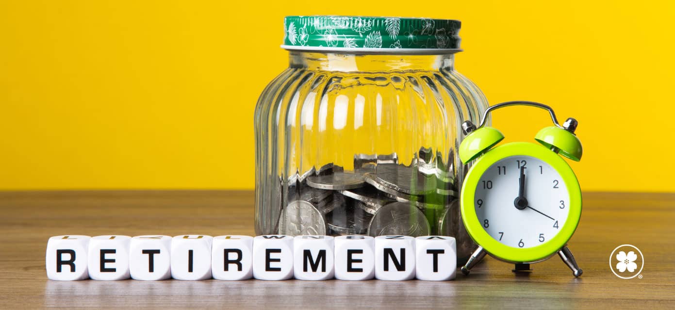 jar with coins sitting behind clock and blocks spelling “retirement”