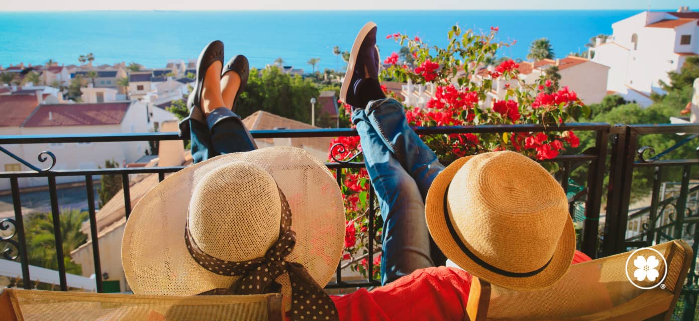 couple vacationing overseas, enjoying the view with feet propped up